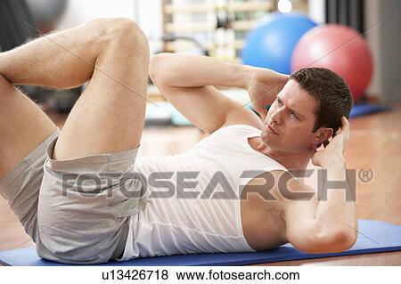 Man Doing Stretching Exercises In Gym View Large Photo Image Stock Photo - Man Doing Stretching Exercises In Gym. Fotosearch