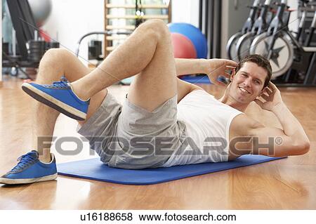 Stock Photo - Man Doing Stretching Exercises In Gym. Fotosearch