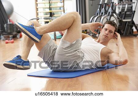 Man Doing Stretching Exercises In Gym View Large Photo Image Stock Photo - Man Doing Stretching Exercises In Gym. Fotosearch