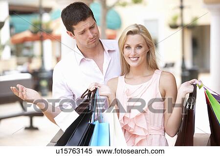 Man Frustrated With Woman On Shopping Trip Together View Large Photo Image Stock Photography - Man Frustrated With Woman On Shopping Trip Together. Fotosearch