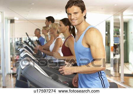 Picture - Man On Running Machine In Gym. Fotosearch