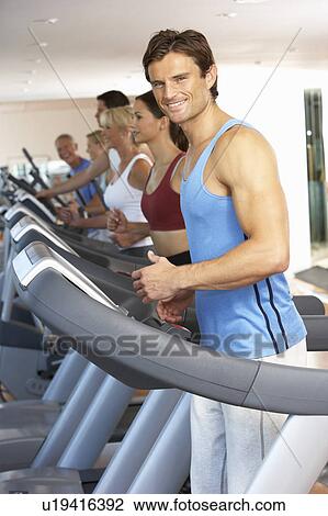 Stock Image - Man On Running Machine In Gym. Fotosearch