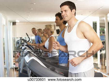 Stock Image - Man On Running Machine In Gym. Fotosearch