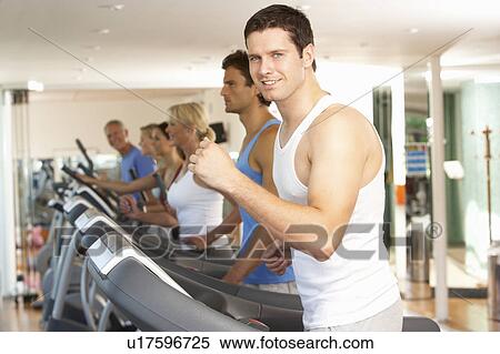 Stock Photography - Man On Running Machine In Gym. Fotosearch
