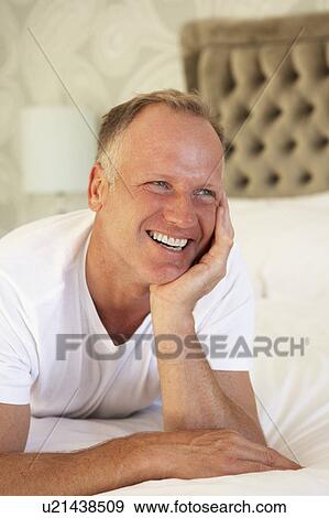 Man Relaxing In Bedroom View Large Photo Image Stock Photo - Man Relaxing In Bedroom. Fotosearch