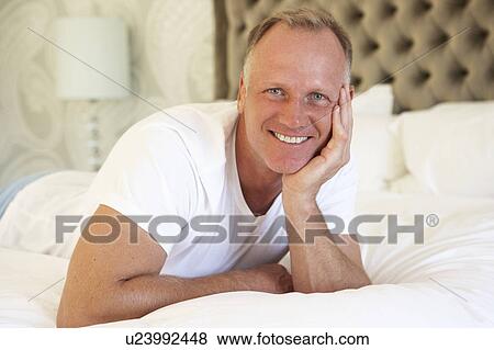 Man Relaxing In Bedroom View Large Photo Image Stock Photo - Man Relaxing In Bedroom. Fotosearch
