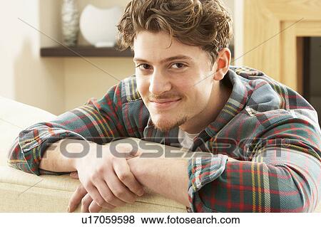 Man Relaxing On Sofa At Home View Large Photo Image Stock Photo - Man Relaxing On Sofa At Home. Fotosearch