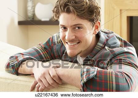 Man Relaxing On Sofa At Home View Large Photo Image Stock Photograph - Man Relaxing On Sofa At Home. Fotosearch