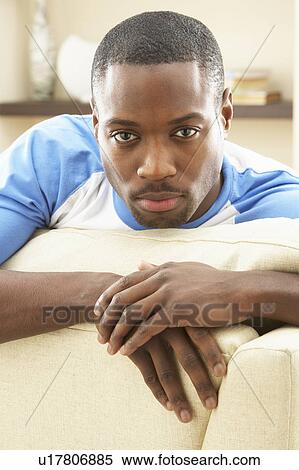 Stock Photography - Man Relaxing On Sofa At Home. Fotosearch
