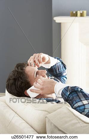 Man Relaxing Sitting On Sofa At Home Talking On Phone View Large Photo Image Stock Photo - Man Relaxing Sitting On Sofa At Home Talking On Phone. Fotosearch