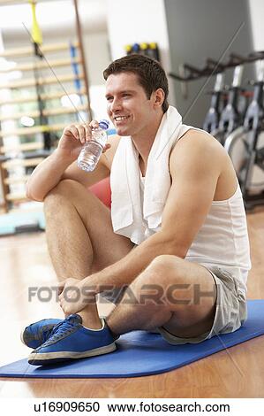 Stock Image - Man Resting After Exercises In Gym. Fotosearch