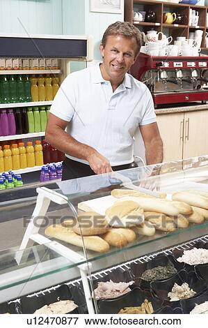 Man Working Behind Counter In Café View Large Photo Image Stock Photo - Man Working Behind Counter In Café. Fotosearch