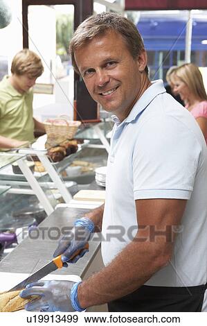 Stock Photo - Man Working Behind Counter In Café. Fotosearch