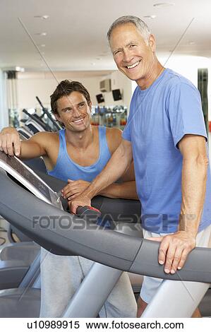 Man Working With Personal Trainer On Running Machine In Gym View Large Photo Image Stock Photography - Man Working With Personal Trainer On Running Machine In Gym. Fotosearch