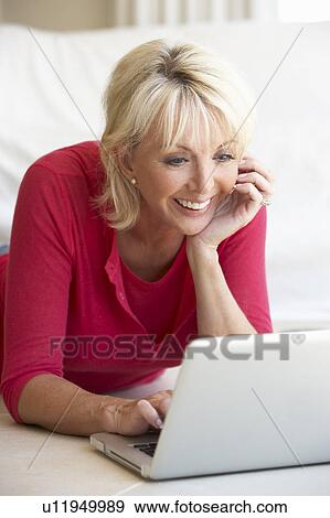 Middle age woman on her laptop computer View Large Photo Image Stock Photo - Middle age woman on her laptop computer. Fotosearch