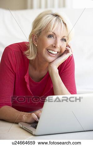 Stock Photo - Middle age woman on her laptop computer. Fotosearch