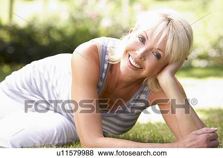Middle age woman posing in park View Large Photo Image Stock Photo - Middle age woman posing in park. Fotosearch