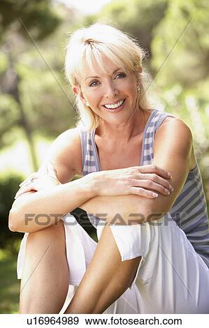 Stock Photo - Middle age woman posing in park. Fotosearch
