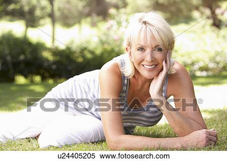 Stock Photography - Middle age woman posing in park. Fotosearch