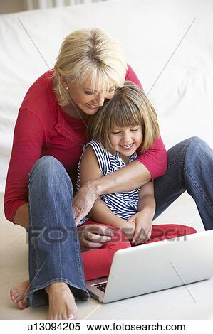 Middle age woman with young girl using laptop computer View Large Photo Image Stock Photography - Middle age woman with young girl using laptop computer. Fotosearch