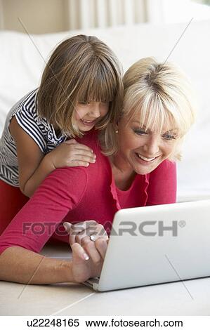 Middle age woman with young girl using laptop computer View Large Photo Image Stock Photography - Middle age woman with young girl using laptop computer. Fotosearch