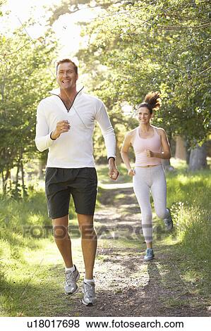 Middle Aged Couple Jogging In Park View Large Photo Image Stock Photo - Middle Aged Couple Jogging In Park. Fotosearch