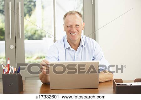 Middle Aged Man Using Laptop At Home View Large Photo Image Stock Image - Middle Aged Man Using Laptop At Home. Fotosearch