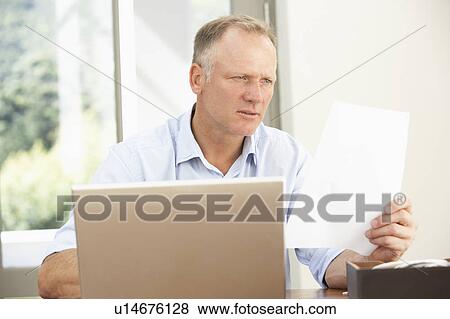 Middle Aged Man Using Laptop At Home View Large Photo Image Stock Photo - Middle Aged Man Using Laptop At Home. Fotosearch