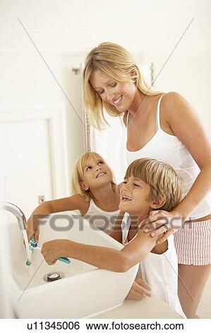 Mother And Children Brushing Teeth In Bathroom Together View Large Photo Image Stock Photograph - Mother And Children Brushing Teeth In Bathroom Together. Fotosearch