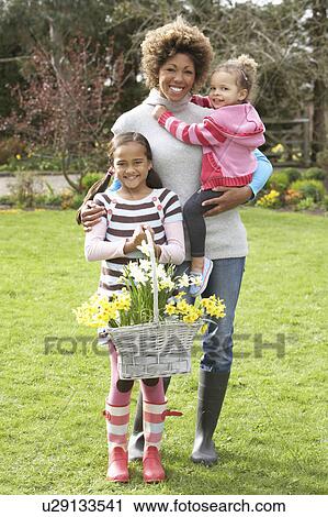 Mother And Children Holding Basket Of Daffodils In Garden View Large Photo Image Stock Image - Mother And Children Holding Basket Of Daffodils In Garden. Fotosearch