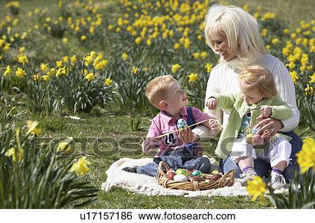 Mother And Children In Daffodil Field With Decorated Easter Eggs View Large Photo Image Stock Photograph - Mother And Children In Daffodil Field With Decorated Easter Eggs. Fotosearch