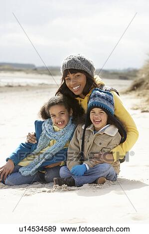 Stock Photo - Mother And Children On Winter Beach. Fotosearch