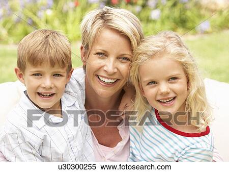 Stock Photography - Mother And Children Relaxing In Garden. Fotosearch