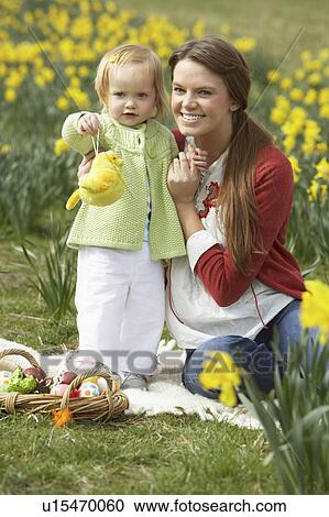 Mother And Daughter In Daffodil Field With Decorated Easter Eggs View Large Photo Image Stock Image - Mother And Daughter In Daffodil Field With Decorated Easter Eggs. Fotosearch