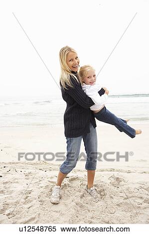 Mother And Daughter On Holiday Having Fun On Winter Beach View Large Photo Image Stock Photography - Mother And Daughter On Holiday Having Fun On Winter Beach. Fotosearch