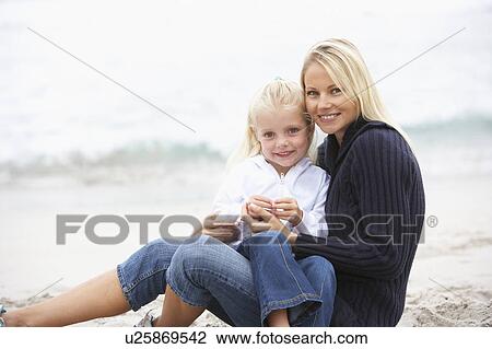 Mother And Daughter On Holiday Sitting On Winter Beach View Large Photo Image Stock Image - Mother And Daughter On Holiday Sitting On Winter Beach. Fotosearch