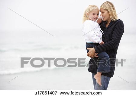 Mother And Daughter On Holiday Standing On Winter Beach View Large Photo Image Stock Photo - Mother And Daughter On Holiday Standing On Winter Beach. Fotosearch