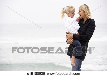 Mother And Daughter On Holiday Standing On Winter Beach View Large Photo Image Stock Photography - Mother And Daughter On Holiday Standing On Winter Beach. Fotosearch