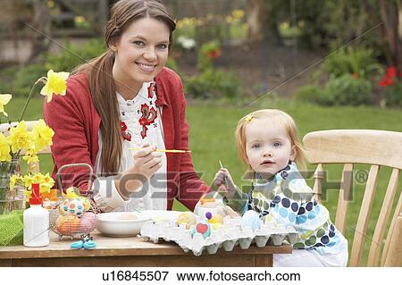 Mother And Daughter Painting Easter Eggs In Gardens View Large Photo Image Stock Photo - Mother And Daughter Painting Easter Eggs In Gardens. Fotosearch