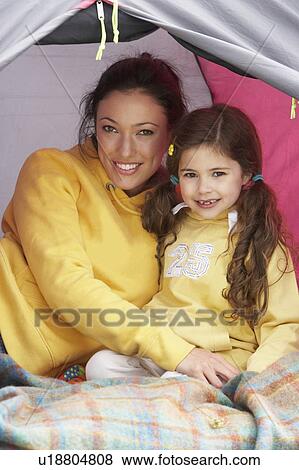 Mother And Daughter Relaxing Inside Tent On Camping Holiday View Large Photo Image Stock Photo - Mother And Daughter Relaxing Inside Tent On Camping Holiday. Fotosearch