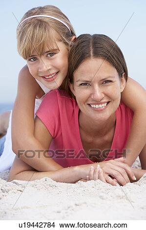 Mother And Daughter Relaxing On Beach Holiday View Large Photo Image Picture - Mother And Daughter Relaxing On Beach Holiday. Fotosearch
