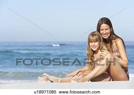 Mother And Daughter Relaxing Together On Beach Holiday View Large Photo Image Stock Photography - Mother And Daughter Relaxing Together On Beach Holiday. Fotosearch