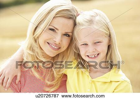 Mother And Daughter Sitting On Straw Bales In Harvested Field View Large Photo Image Stock Photo - Mother And Daughter Sitting On Straw Bales In Harvested Field. Fotosearch