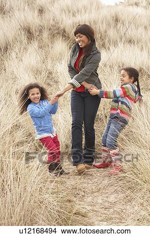 Mother And Daughters Having Fun In Sand Dunes View Large Photo Image Picture - Mother And Daughters Having Fun In Sand Dunes. Fotosearch