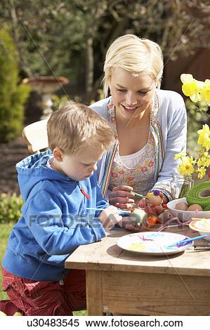 Mother And Son Decorating Easter Eggs On Table Outdoors View Large Photo Image Stock Photography - Mother And Son Decorating Easter Eggs On Table Outdoors . Fotosearch
