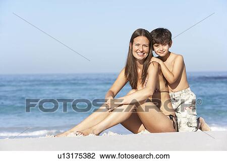 Mother And Son Relaxing Together On Beach Holiday View Large Photo Image Stock Image - Mother And Son Relaxing Together On Beach Holiday. Fotosearch