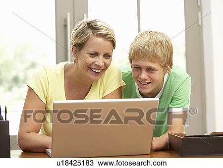 Mother And Teenage Son Using Laptop At Home View Large Photo Image Stock Image - Mother And Teenage Son Using Laptop At Home. Fotosearch