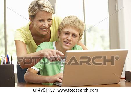Mother And Teenage Son Using Laptop At Home View Large Photo Image Stock Photo - Mother And Teenage Son Using Laptop At Home. Fotosearch