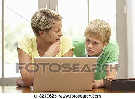 Mother And Teenage Son Using Laptop At Home View Large Photo Image Stock Photography - Mother And Teenage Son Using Laptop At Home. Fotosearch
