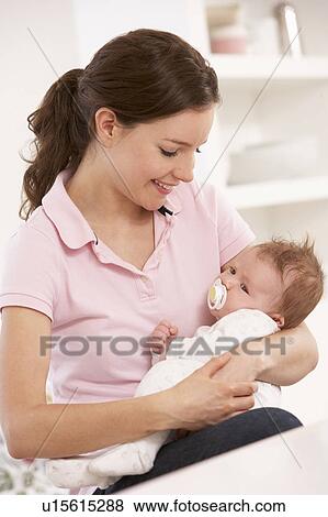Mother Cuddling Baby Boy At Home View Large Photo Image Stock Photo - Mother Cuddling Baby Boy At Home. Fotosearch